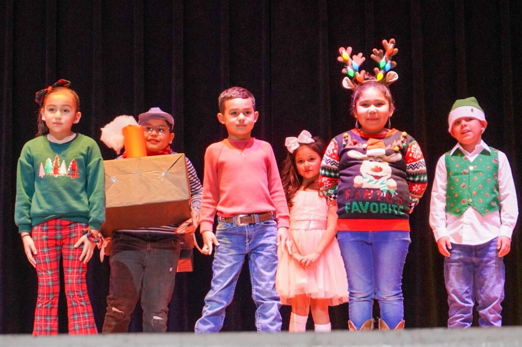 elementary students on stage performing holiday songs